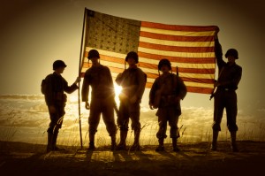 WWII Soldiers Standing In A Flag Draped Sunset - SIlhouette